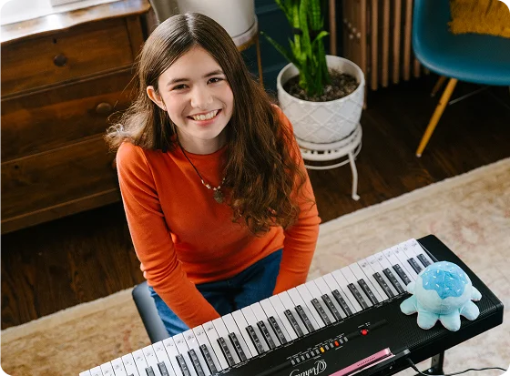 Una estudiante junto a su piano